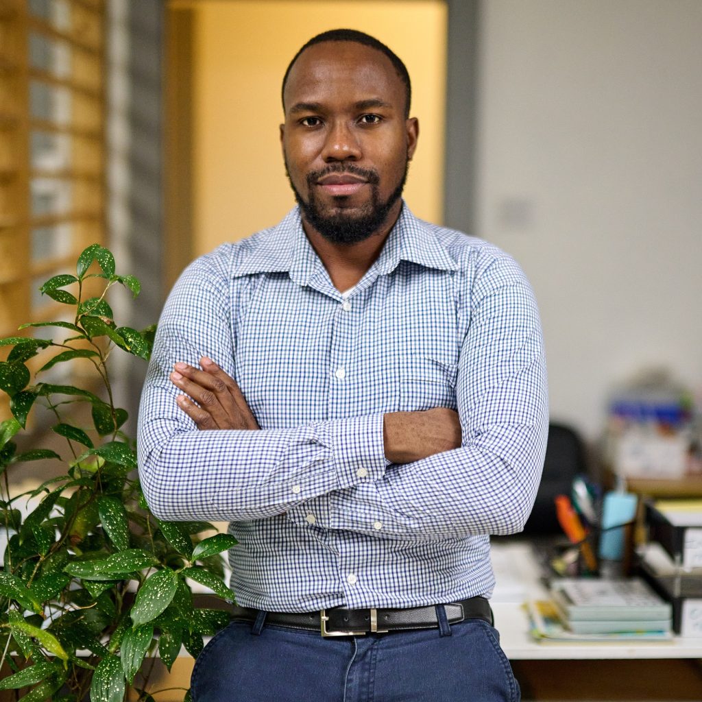 Young African American CEO standing in his office